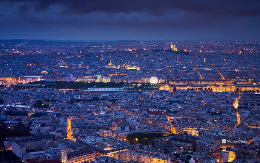 Aerial view of Paris at dusk with the Tuileries Garden, the Louvre and the Sacré-Cœur de Montmartre