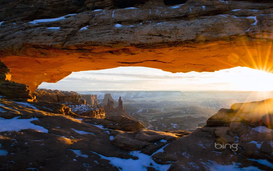 The sun peeks through Mesa Arch in Canyonlands National Park, Utah