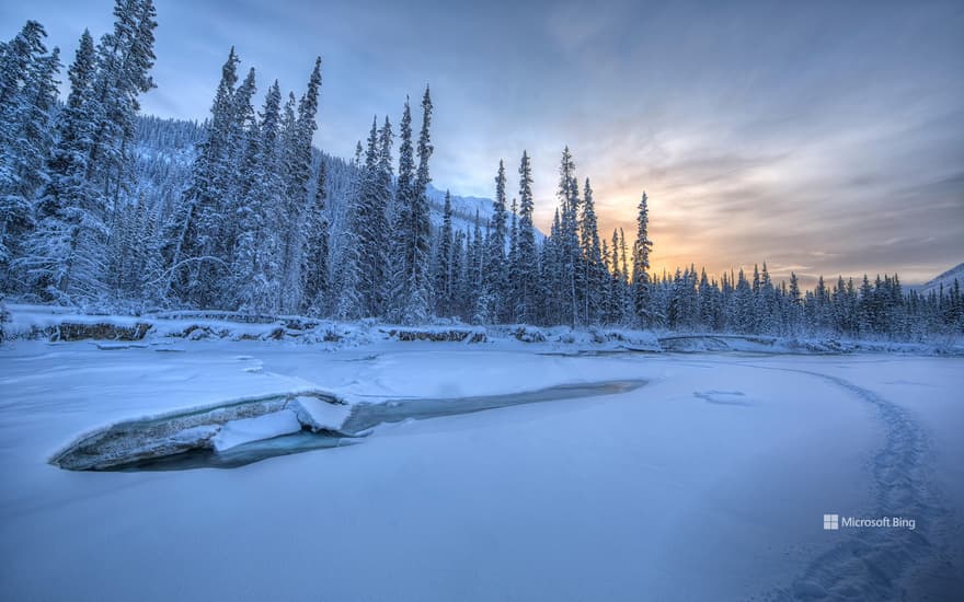 Sunset colours over the icy Wheaton River, Yukon, Canada